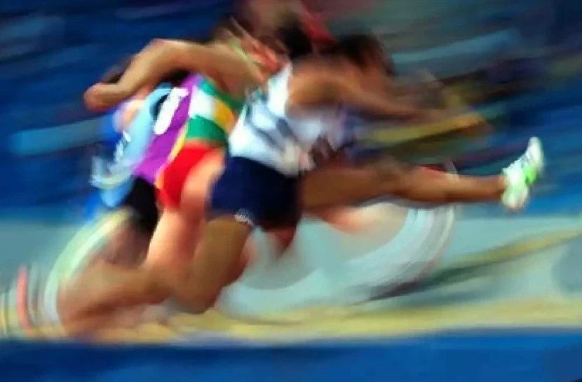 Track athletes in competition, illustrating the sports sector