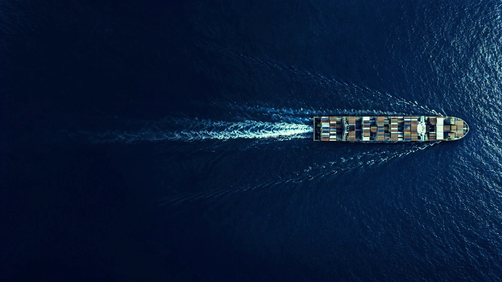Container ship crossing deep blue water